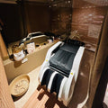 Massage chair in a modern interior setting with mirrors and decor elements.